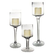 Pillar candles in tall stemmed glass candle holders