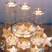 Glitter star floating candles centerpiece uses glass cylinders and glass bowl