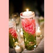 floating candle centerpiece with submerged flower on stem